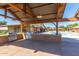Covered outdoor BBQ area features stainless steel grills and concrete floor at 15469 W Dreyfus St, Surprise, AZ 85379