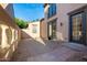 This backyard features gravel landscaping, a small patio and access doors to the home at 15469 W Dreyfus St, Surprise, AZ 85379