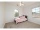 This bedroom has carpeted floors, a bed, and natural light from two windows at 15469 W Dreyfus St, Surprise, AZ 85379