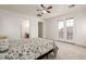 Bright bedroom boasts neutral carpet, ceiling fan, and French doors at 15469 W Dreyfus St, Surprise, AZ 85379