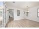 Open dining room featuring wood-look floors, elegant chandelier, and ample natural light at 15469 W Dreyfus St, Surprise, AZ 85379