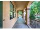 Covered walkway has neutral color scheme and decorative metal handrail at 15469 W Dreyfus St, Surprise, AZ 85379