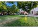 Charming home featuring a well-manicured lawn and mature trees enhancing its curb appeal at 15469 W Dreyfus St, Surprise, AZ 85379
