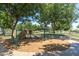 Community playground with swings, slide, and climbing structure for Gathering fun at 15469 W Dreyfus St, Surprise, AZ 85379
