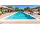 Long community pool featuring a handicap chair lift and sunbathing area at 15469 W Dreyfus St, Surprise, AZ 85379