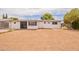 View of the back of the house with large backyard and minimalist landscaping at 1654 E 2Nd St, Mesa, AZ 85203