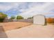 Spacious backyard featuring a storage shed, concrete patio, and block wall at 1654 E 2Nd St, Mesa, AZ 85203