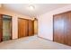 Bedroom with attached bathroom, neutral carpet, and double closets at 1654 E 2Nd St, Mesa, AZ 85203