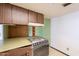 The kitchen features an older stove with vintage style, and dark wooden cabinets at 1654 E 2Nd St, Mesa, AZ 85203