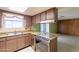 Retro kitchen featuring vintage appliances, wood cabinetry, and durable laminate countertops at 1654 E 2Nd St, Mesa, AZ 85203