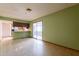 An empty living room with green walls, linoleum floors and access to the kitchen and the yard at 1654 E 2Nd St, Mesa, AZ 85203