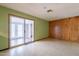 The living room has retro wood paneling, green walls, and a sliding door to the backyard at 1654 E 2Nd St, Mesa, AZ 85203