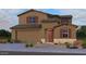Charming two-story home with a two-car garage, desert landscaping, and covered entryway at 17018 W Shangri La Rd, Surprise, AZ 85388