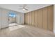 Open bedroom with sliding glass door, decorative wall, and light wood floor at 1717 E Union Hills Dr # 1033, Phoenix, AZ 85024