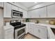 Well-lit kitchen with white cabinets, stainless steel appliances, and light countertops at 1717 E Union Hills Dr # 1033, Phoenix, AZ 85024