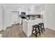 Bright, modern kitchen with white cabinets, stainless steel appliances, breakfast bar, and sleek black barstools for casual dining at 1717 E Union Hills Dr # 1033, Phoenix, AZ 85024