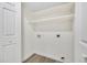 A bright laundry room features wood-look floors and white shelving at 1717 E Union Hills Dr # 1033, Phoenix, AZ 85024