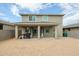 A backyard featuring a covered patio, grill, and ample open space surrounded by walls at 18813 W Solano Dr, Litchfield Park, AZ 85340