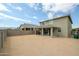 Exterior shot of the backyard showing the back of the home and back patio at 18813 W Solano Dr, Litchfield Park, AZ 85340