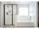 Bathroom features a glass-enclosed shower and a separate bathtub with natural light at 18813 W Solano Dr, Litchfield Park, AZ 85340