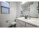Clean bathroom features a white vanity, updated fixtures, and a shower-tub combo at 18813 W Solano Dr, Litchfield Park, AZ 85340