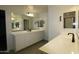 Bright bathroom with dual sinks, white cabinets, and a large mirror for a modern feel at 18813 W Solano Dr, Litchfield Park, AZ 85340