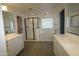 Beautiful bathroom featuring double sinks, shower, soaking tub, and tile flooring at 18813 W Solano Dr, Litchfield Park, AZ 85340