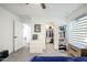 An airy bedroom boasts a closet and dresser, bathed in natural light from the window at 18813 W Solano Dr, Litchfield Park, AZ 85340