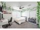 A cozy bedroom with a ceiling fan, charming vines and a light-filled window at 18813 W Solano Dr, Litchfield Park, AZ 85340