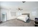 Large bedroom with a ceiling fan, carpeted floors and ample natural light at 18813 W Solano Dr, Litchfield Park, AZ 85340