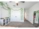 A bright bedroom featuring a closet and gray carpet, decorated with hanging green vines at 18813 W Solano Dr, Litchfield Park, AZ 85340