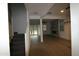 Hallway with wood and carpet flooring, leading to a living room with a fireplace at 18813 W Solano Dr, Litchfield Park, AZ 85340