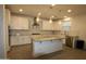 Inviting kitchen with white cabinets, granite countertops, and a large center island at 18813 W Solano Dr, Litchfield Park, AZ 85340
