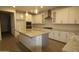 Bright kitchen with stainless steel appliances, granite countertops, and large kitchen island at 18813 W Solano Dr, Litchfield Park, AZ 85340