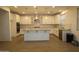 Modern kitchen featuring a spacious island, stainless steel appliances, and white cabinetry at 18813 W Solano Dr, Litchfield Park, AZ 85340