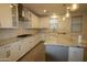 Beautiful kitchen showcasing stainless appliances, granite countertops, and spacious island at 18813 W Solano Dr, Litchfield Park, AZ 85340