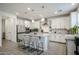 Spacious kitchen features an island with seating and modern stainless steel appliances at 18813 W Solano Dr, Litchfield Park, AZ 85340