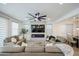Bright living room with a fireplace, large television, and comfortable seating at 18813 W Solano Dr, Litchfield Park, AZ 85340