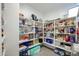 Well-stocked pantry with ample shelving and organization for food and household supplies at 18813 W Solano Dr, Litchfield Park, AZ 85340