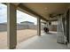 A covered patio includes a ceiling fan, heater, and grill, set against a walled backyard at 18813 W Solano Dr, Litchfield Park, AZ 85340