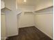 Large walk-in closet with built-in shelving for storage with neutral walls and carpet at 18813 W Solano Dr, Litchfield Park, AZ 85340