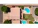 An aerial view displays a home, pool, yard, and neighboring houses, all set against a desert background at 20404 N 28Th Pl, Phoenix, AZ 85050