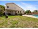 Large backyard featuring mature landscaping, a sparkling pool, covered patio, and second story balcony at 20404 N 28Th Pl, Phoenix, AZ 85050