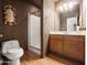 Cozy bathroom featuring a step-in shower with glass door and a decorative mirror at 20404 N 28Th Pl, Phoenix, AZ 85050