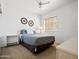Cozy bedroom with a ceiling fan, large window, and neutral decor at 20404 N 28Th Pl, Phoenix, AZ 85050