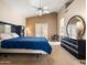 Bright bedroom featuring a king-size bed, ceiling fan, and French doors to the backyard at 20404 N 28Th Pl, Phoenix, AZ 85050