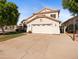Two-story home featuring a well-maintained lawn, mature trees, and a spacious two-car garage at 20404 N 28Th Pl, Phoenix, AZ 85050