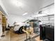 A garage featuring overhead lighting, shelving, a parked car, and multiple household items for storage at 20404 N 28Th Pl, Phoenix, AZ 85050