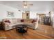 Open living room features hardwood floors, ceiling fan, and access to the kitchen area at 20404 N 28Th Pl, Phoenix, AZ 85050