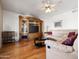Living room with hardwood floors showcases a large entertainment center with glass shelves at 20404 N 28Th Pl, Phoenix, AZ 85050